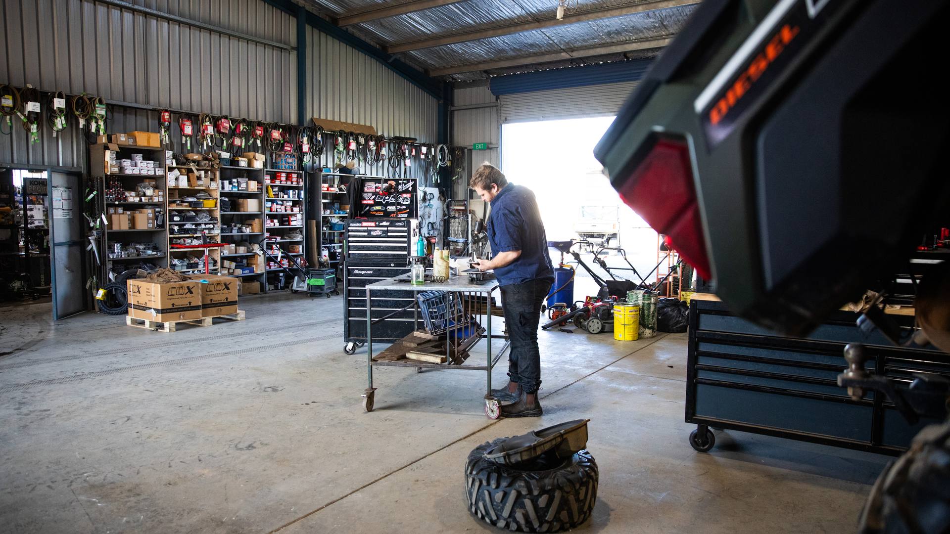 Mechanic working at the bench in the Forbes Small Engine Specialists workshop