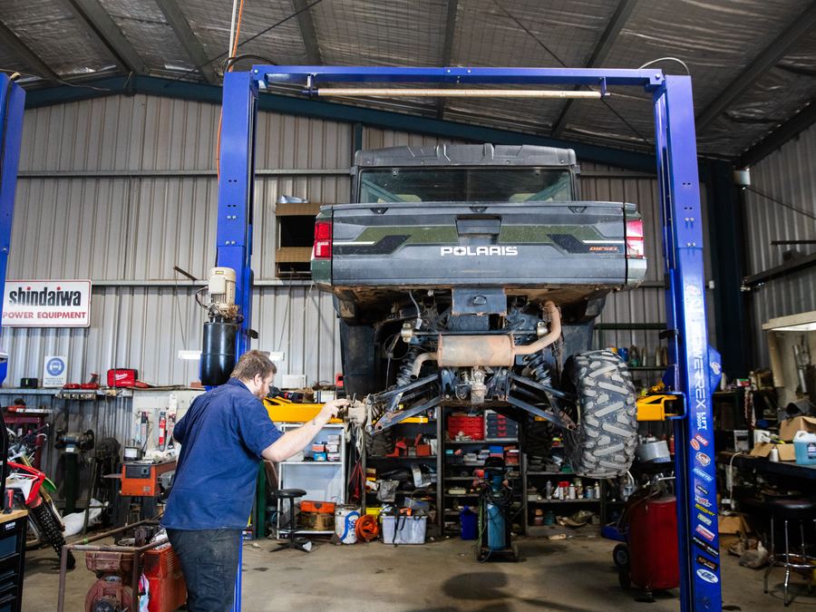 Polaris Ranger on the workshop hoist being serviced in Forbes