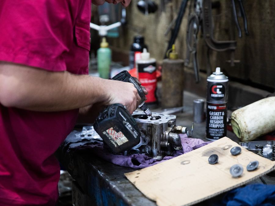 Small engine cylinder head being repaired on the workshop bench in Forbes